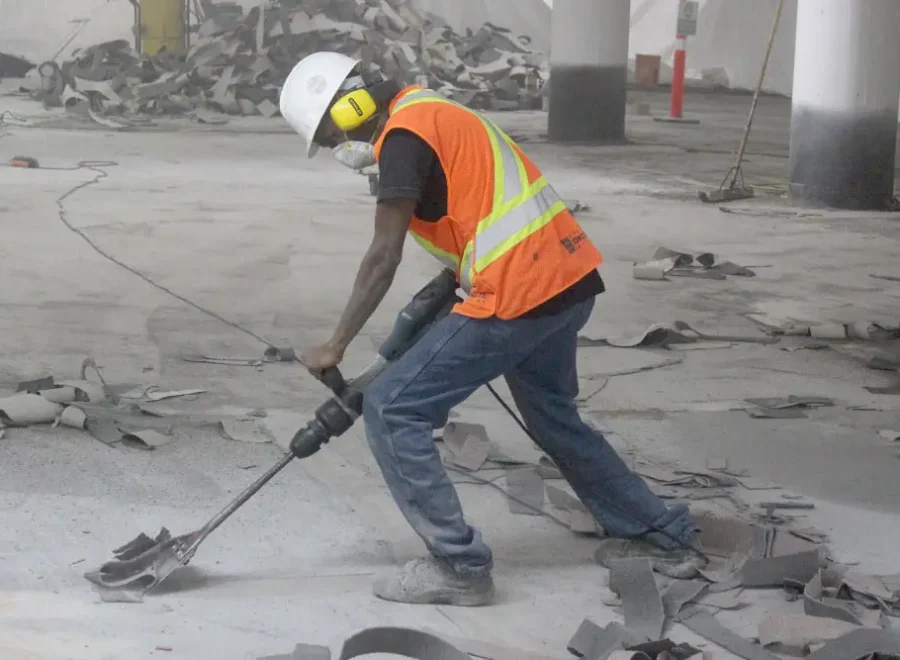 ICC worker scraping parking garage floor